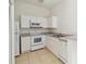 Efficient kitchen features appliances, white cabinets, and tile floors at 2828 Club Cortile Cir # B, Kissimmee, FL 34746
