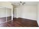 Bright, spacious primary bedroom with dark wood floors, ceiling fan, and closet at 2828 Club Cortile Cir # B, Kissimmee, FL 34746
