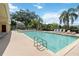 Large community pool with ample seating and lush landscaping at 2828 Club Cortile Cir # B, Kissimmee, FL 34746