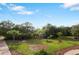 Picturesque backyard showcases mature trees, lush landscaping, and a well-manicured lawn at 2851 Wagon Ct, St Cloud, FL 34772