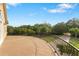 Expansive balcony with iron railing offers scenic views of lush greenery and landscaping at 2851 Wagon Ct, St Cloud, FL 34772
