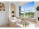 Luxurious bathroom with a large soaking tub, gold fixtures, and a scenic window view at 2851 Wagon Ct, St Cloud, FL 34772