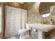 Bathroom boasts tiled walls, a stylish sink, and a decorative shower curtain adding charm at 2851 Wagon Ct, St Cloud, FL 34772