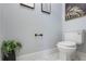 Half bathroom featuring a toilet, plants, and toilet paper holder at 2851 Wagon Ct, St Cloud, FL 34772