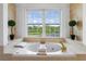 Luxurious bathtub with marble surround and a scenic view from the large window at 2851 Wagon Ct, St Cloud, FL 34772