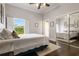 Cozy bedroom with neutral tones, hardwood floors, ample natural light, and a mirror closet door at 2851 Wagon Ct, St Cloud, FL 34772