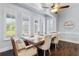 Bright dining area with plantation shutters, hardwood floors, a ceiling fan, and transitional furniture at 2851 Wagon Ct, St Cloud, FL 34772