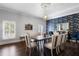 Formal dining room with seating for eight, stylish wallpaper, and plantation shutters at 2851 Wagon Ct, St Cloud, FL 34772