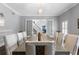 Elegant dining room with hardwood floors, gray walls, and a modern light fixture with seating for ten at 2851 Wagon Ct, St Cloud, FL 34772