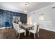 Stunning dining room features dark wood floors, modern chairs, and an ornate light fixture and dark wall paper at 2851 Wagon Ct, St Cloud, FL 34772