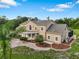 An exterior side-view of a two-story home with manicured landscaping, a brick driveway, and a screened in pool at 2851 Wagon Ct, St Cloud, FL 34772