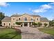 Stately two-story home with a circular driveway, elegant columns, and a beautiful facade at 2851 Wagon Ct, St Cloud, FL 34772