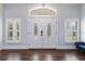 Elegant foyer features double doors with decorative glass and stylish wood floors at 2851 Wagon Ct, St Cloud, FL 34772