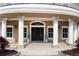 Elegant front entrance with double doors, white columns, and a paved walkway at 2851 Wagon Ct, St Cloud, FL 34772