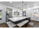 Modern kitchen features an island with seating, stainless steel appliances, and white cabinetry at 2851 Wagon Ct, St Cloud, FL 34772