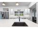 Bright kitchen featuring an island with quartz countertops, stainless steel appliances and white cabinets at 2851 Wagon Ct, St Cloud, FL 34772