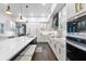 Modern white kitchen with gold accents, featuring an island, stainless steel appliances, and wood floors at 2851 Wagon Ct, St Cloud, FL 34772