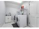 Functional laundry room featuring modern washer and dryer units and built-in sink at 2851 Wagon Ct, St Cloud, FL 34772