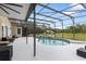 Screened in pool area with comfortable seating and views of the grassy backyard at 2851 Wagon Ct, St Cloud, FL 34772