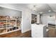 Spacious walk-in closet features custom shelving, center island, chandelier, and hardwood floors at 2851 Wagon Ct, St Cloud, FL 34772