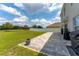 An expansive backyard with a stone patio is perfect for outdoor dining and lounging at 3053 Royal Tern Dr, Winter Haven, FL 33881