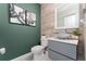 Stylish powder room featuring wood-look tile, sleek vanity, and modern vessel sink at 3053 Royal Tern Dr, Winter Haven, FL 33881