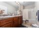 Bathroom with double vanity, shower-tub combination and neutral color scheme provides a calming atmosphere at 3053 Royal Tern Dr, Winter Haven, FL 33881