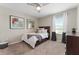 Cozy bedroom with natural light, a ceiling fan, and plush carpeting, offering comfort at 3053 Royal Tern Dr, Winter Haven, FL 33881