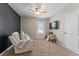 Comfortable bedroom featuring a ceiling fan, cozy seating area, and plush carpeting at 3053 Royal Tern Dr, Winter Haven, FL 33881