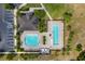 Aerial view showcasing the community pool area featuring multiple pools, sun loungers, and lush landscaping at 3053 Royal Tern Dr, Winter Haven, FL 33881