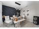 A modern dining room featuring a stylish light fixture, seating for six, and decorative wall art at 3053 Royal Tern Dr, Winter Haven, FL 33881