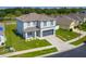 Aerial view of a modern two-story home with a well-kept lawn in a residential neighborhood at 3053 Royal Tern Dr, Winter Haven, FL 33881