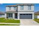 Charming two-story home with a well-manicured lawn and an attached two-car garage at 3053 Royal Tern Dr, Winter Haven, FL 33881