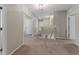 Upstairs hallway with multiple doors and neutral carpeting throughout the second story at 3053 Royal Tern Dr, Winter Haven, FL 33881