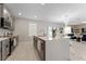 A modern kitchen with stainless steel appliances, a large island, and an open layout at 3053 Royal Tern Dr, Winter Haven, FL 33881