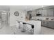 An open kitchen with stainless steel appliances, a large island with seating, and modern finishes at 3053 Royal Tern Dr, Winter Haven, FL 33881