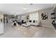 Open-concept living room featuring a stylish decor, a view of the kitchen, and lots of natural light at 3053 Royal Tern Dr, Winter Haven, FL 33881