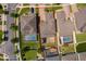 Aerial perspective of the property reveals the lot size, brick driveway, and neighboring houses with pools at 3159 Somerset Park Dr, Orlando, FL 32824