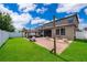 Spacious backyard with a covered patio, outdoor seating, and lush green lawn at 3159 Somerset Park Dr, Orlando, FL 32824