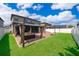 Well-maintained backyard features green grass, a cozy gazebo, and privacy fence at 3159 Somerset Park Dr, Orlando, FL 32824