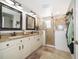 Elegant bathroom featuring dual sinks, granite countertops, and a glass-enclosed shower at 3159 Somerset Park Dr, Orlando, FL 32824