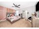 Cozy bedroom featuring a ceiling fan, carpeted floor, and bright decor at 3159 Somerset Park Dr, Orlando, FL 32824