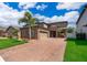 Beautiful home featuring a paver driveway, a two car garage, and manicured lawn at 3159 Somerset Park Dr, Orlando, FL 32824