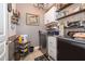 Convenient laundry room with washer, dryer, and shelving for organization at 3159 Somerset Park Dr, Orlando, FL 32824