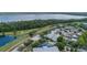 An aerial view of the neighborhood with a lake view and walking path for active community living at 3349 Schoolhouse Rd, Harmony, FL 34773