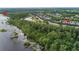 Beautiful aerial view showcasing a lushly landscaped community with waterfront access and community docks and boat facilities at 3349 Schoolhouse Rd, Harmony, FL 34773