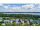A picturesque aerial view shows a lakeside home with solar panels and easy access to walking trails and the lake at 3349 Schoolhouse Rd, Harmony, FL 34773