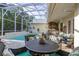 Lovely screened-in lanai with pool, outdoor kitchen, and patio, offering seamless indoor-outdoor living at 3349 Schoolhouse Rd, Harmony, FL 34773