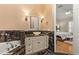 Elegant bathroom with marble accents, featuring a soaking tub and a modern vanity at 3349 Schoolhouse Rd, Harmony, FL 34773