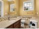 Bathroom with granite countertops, tiled walls, and updated fixtures, creating a serene and functional space at 3349 Schoolhouse Rd, Harmony, FL 34773
